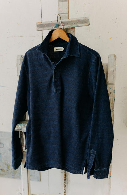 editorial image of The Long Sleeve Polo in Indigo Knit Stripe hanging