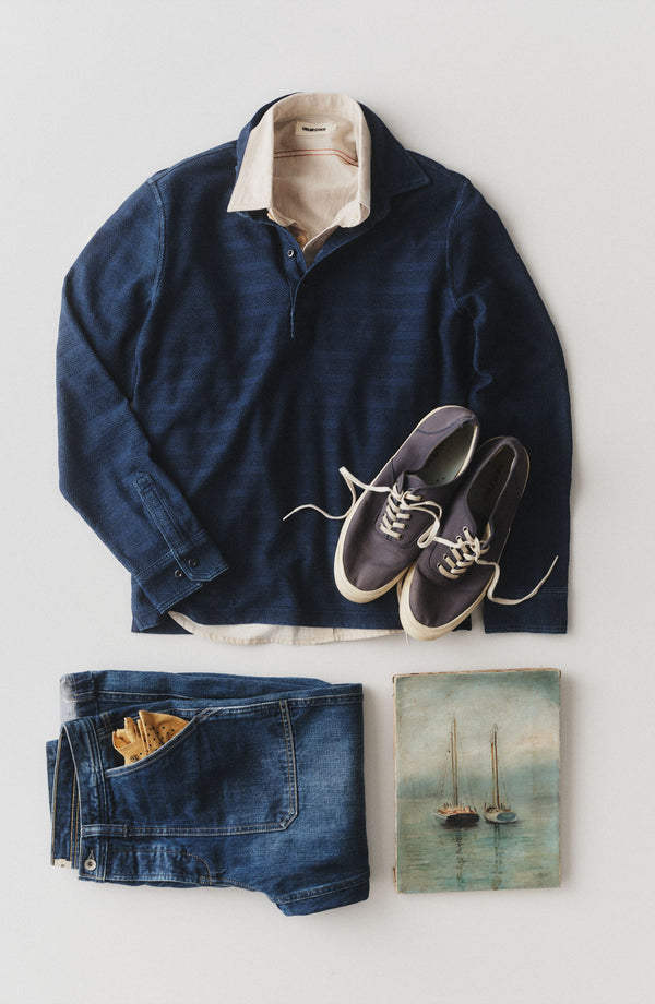 editorial image of The Long Sleeve Polo in Indigo Knit Stripe hanging