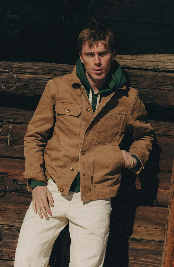 fit model leaning against the wall in The Longshore Jacket in Tobacco Chipped Canvas