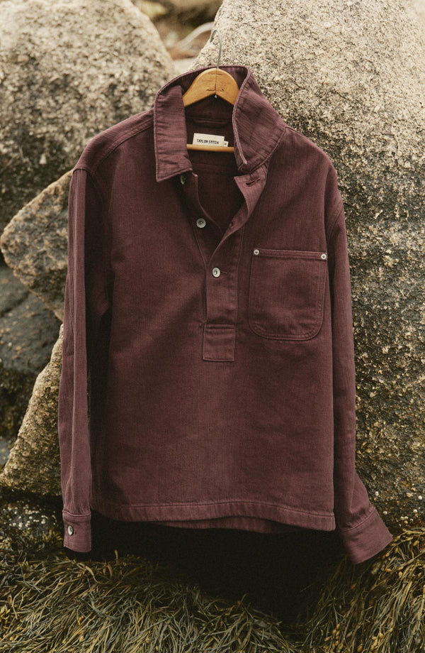 editorial image of The Milton Overshirt in Burgundy Slub Denim hanging
