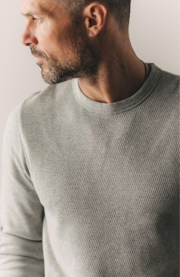 fit model sitting in a car wearing The Organic Cotton Crew in Heather Grey Waffle