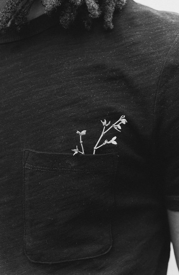 fit model showing off the pocket on The Organic Cotton Tee in Black Indigo