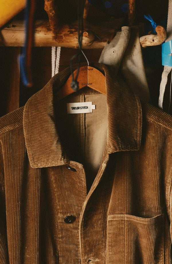 fit model sitting in a seaplane wearing The Ojai Jacket in Bourbon Corduroy