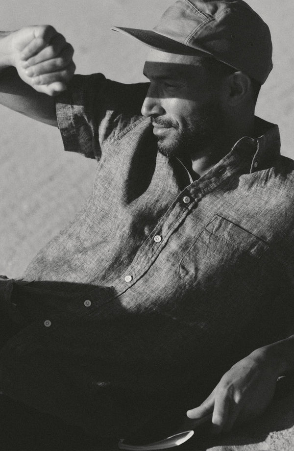 fit model sitting wearing The Short Sleeve Jack in Ocean Linen