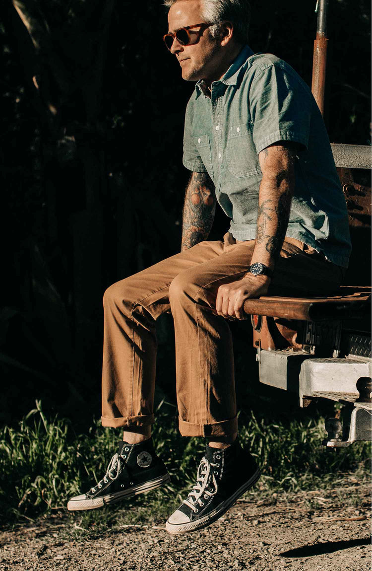 The Short Sleeve Popover in Blue Chambray — Model wearing shirt near outside