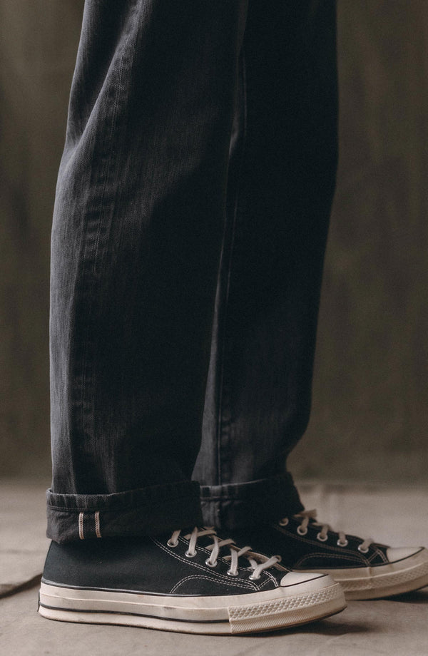 fit model showing off the cuffs on The Straight Jean in Washed Black Organic Slub Selvedge
