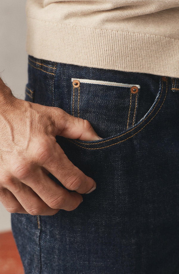 fit model with his hand in the pocket of  The Democratic Jean in Rinsed Organic Selvedge