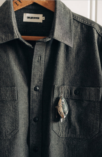 Our model standing in The Utility Shirt in Olive Broken Herringbone