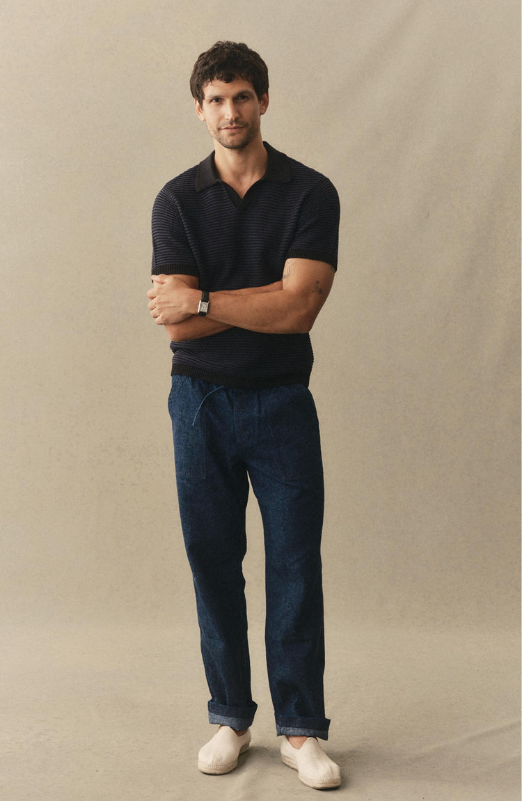 fit model posing in The Valencia Sweater Polo in Coal Stripe