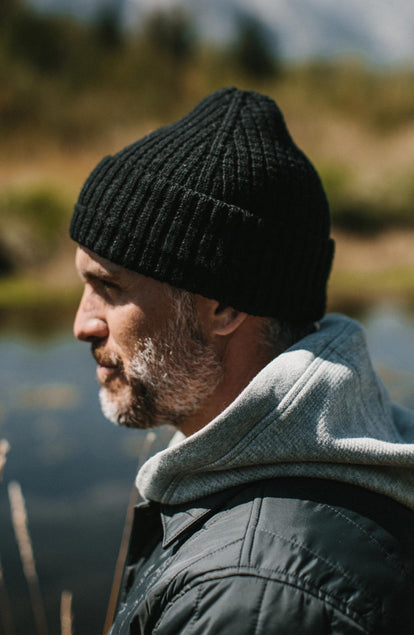Close up of the side of The Waffle Beanie in Coal Merino worn by our model