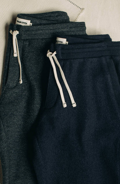 The The Weekend Pant in Navy Boiled Wool laying next to its other colorway