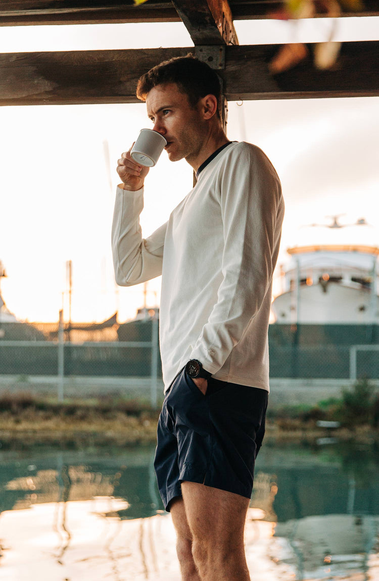 Our guy rocking The Tracksmith Collection long sleeve heavy bag, on a house boat, split shot