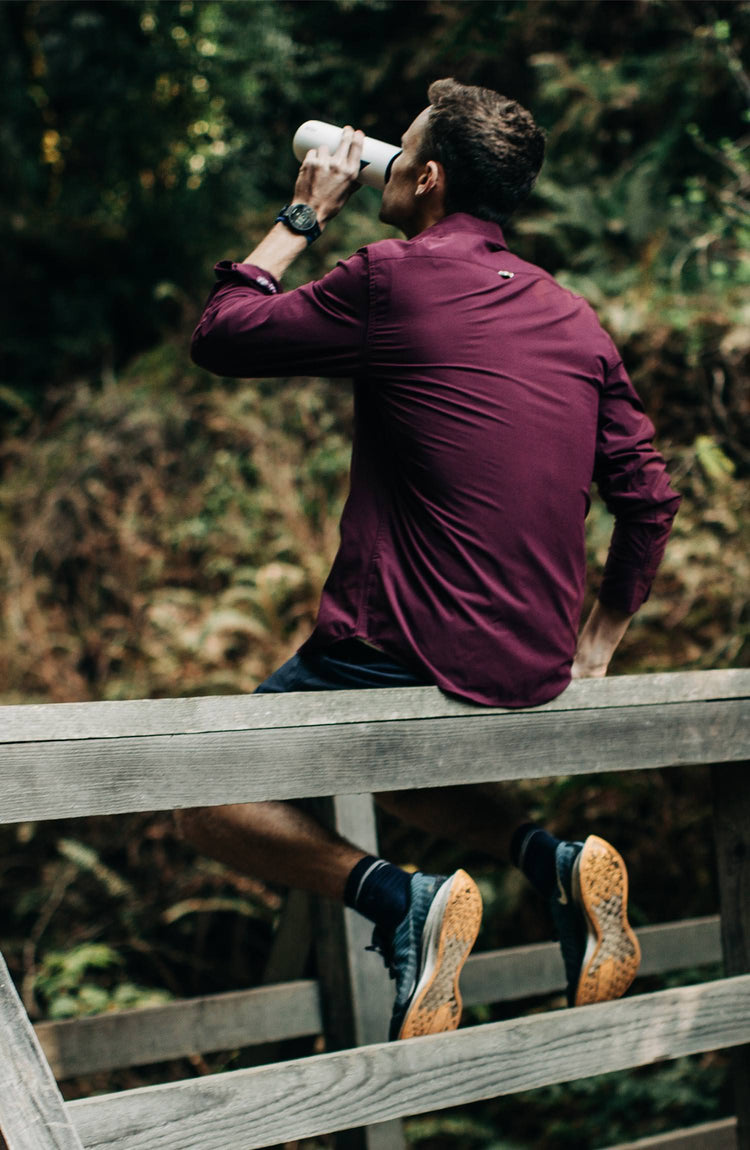 Our guy rocking The Tracksmith Collection over shirt on trail, split shot