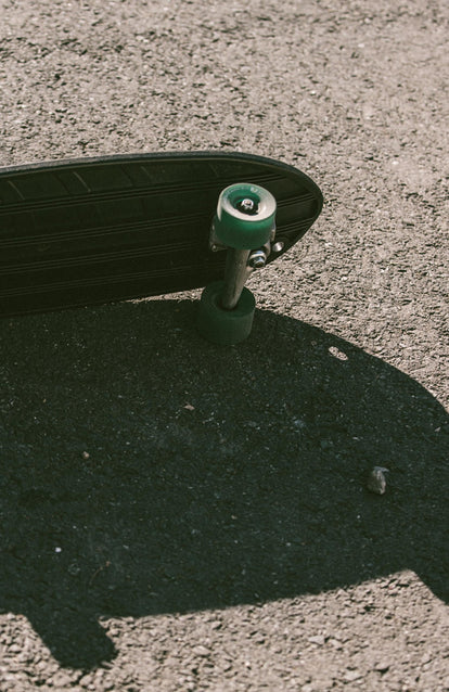 Long shadows from a not so long skateboard.