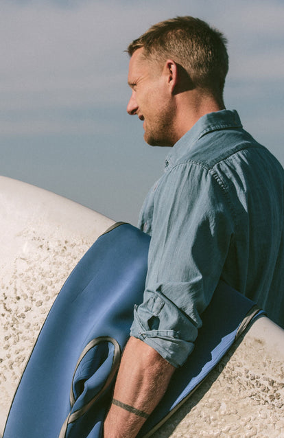 Our guy in his Jack again, sleeves rolled up, board under arm.