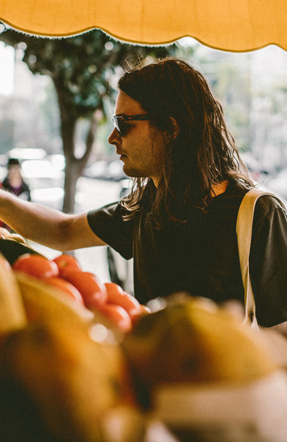 At the market, picking up some produce.
