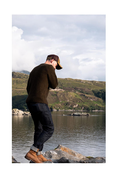 Evan wearing the Fisherman Sweater in Loden in the Scottish Highlands.