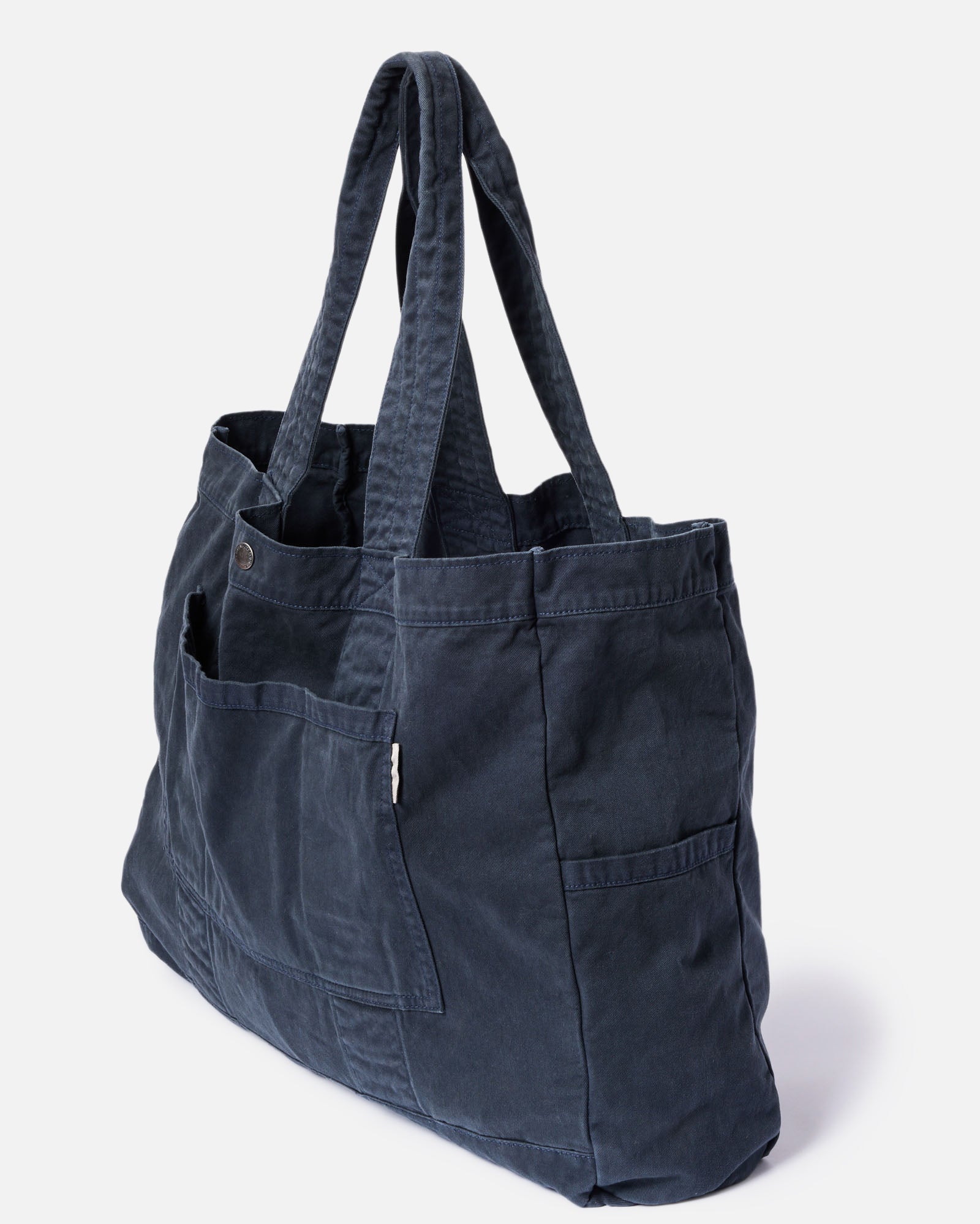 editorial image of the button snap on The Foundation Tote in Organic Navy, Accessories by Taylor Stitch