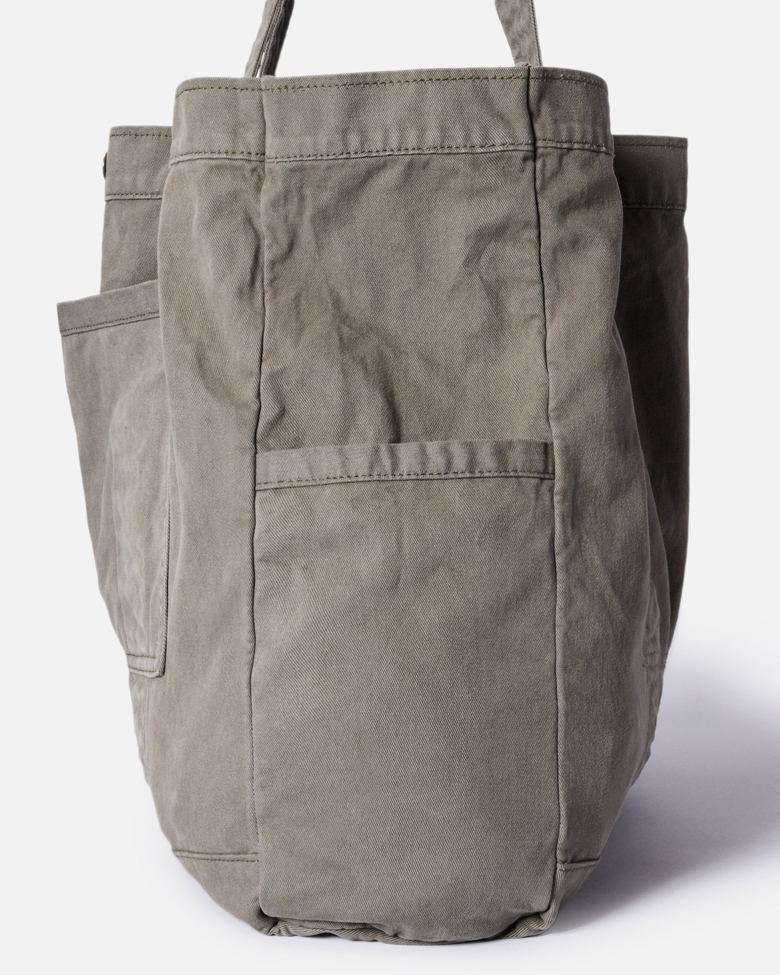 editorial image of the side pocket on The Foundation Tote in Organic Smoked Olive, Accessories by Taylor Stitch