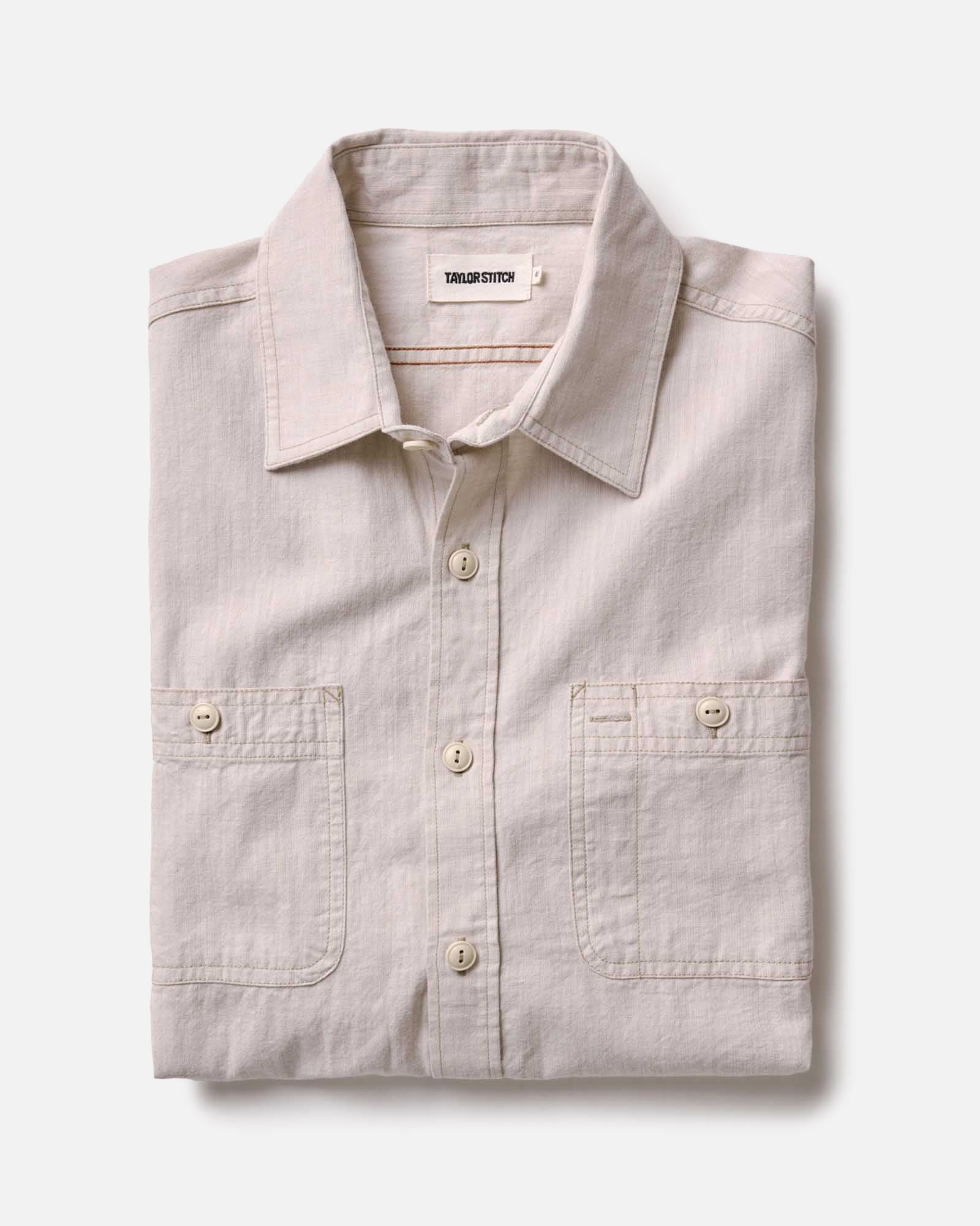 folded flatlay of The Foundry Shirt in Natural Chambray, Wovens by Taylor Stitch
