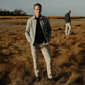 fit model standing in a field in The California in Ash Heather Double Cloth