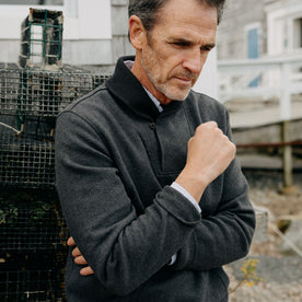 fit model crossing his arms in The Horizon Shawl Pullover in Coal Heather