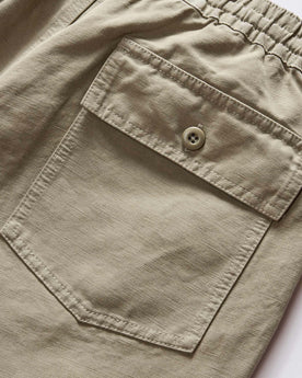 material shot of the back pocket on The Apres Trail Short in Light Sage Slub, Bottoms by Taylor Stitch