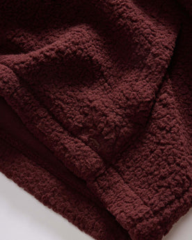 material shot of the kangaroo pocket on The Nomad Hoodie in Burgundy Sherpa, Outerwear by Taylor Stitch