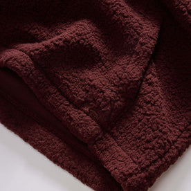 material shot of the kangaroo pocket on The Nomad Hoodie in Burgundy Sherpa