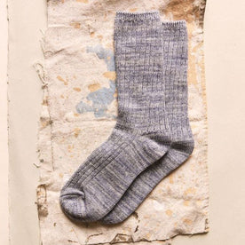 The Rib Sock in Ash Melange on a textured surface