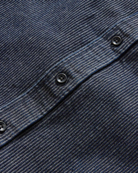 material shot of the charcoal buttons on The Utility Shirt in Rinsed Indigo Stripe, Wovens by Taylor Stitch
