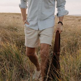 fit model with his hand in the pocket of The Apres Short in Organic Aged Stone Foundation Twill