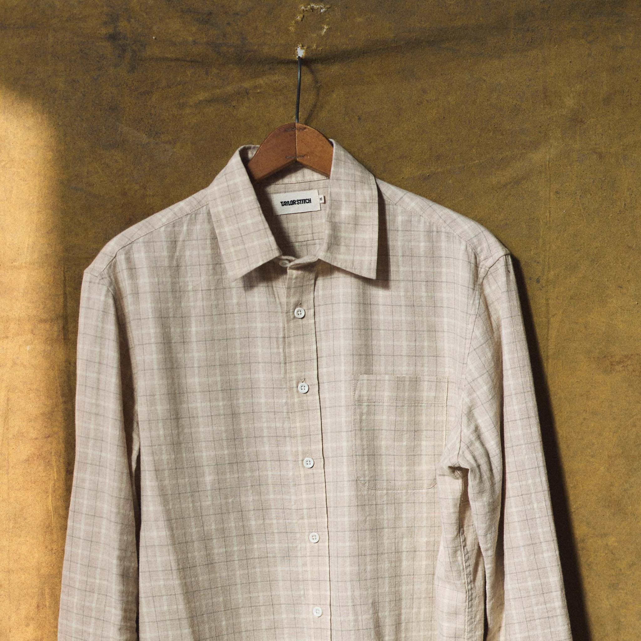 material shot of The California in Russet Plaid hanging on a clothes hanger, Wovens by Taylor Stitch