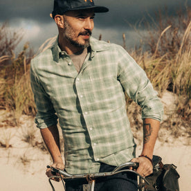 fit model riding a bike wearing The California in Sea Moss Plaid