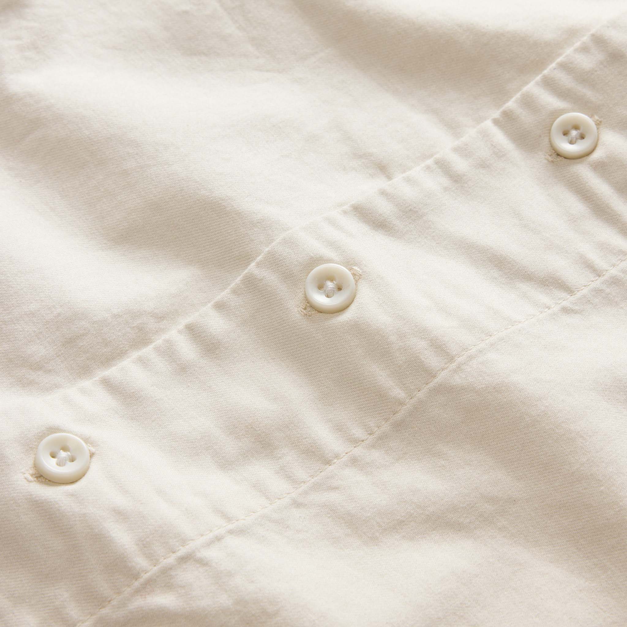 material shot of the buttons on The Conrad Shirt in Seaside Embroidery, Wovens by Taylor Stitch