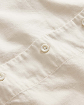 material shot of the buttons on The Conrad Shirt in Seaside Embroidery, Wovens by Taylor Stitch