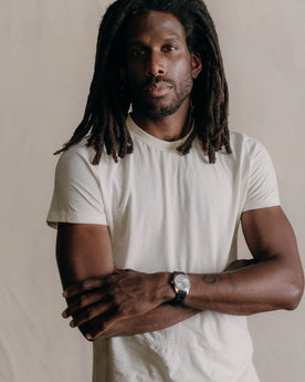 fit model leaning against the wall in The Cotton Hemp Tee in Natural, Knits by Taylor Stitch