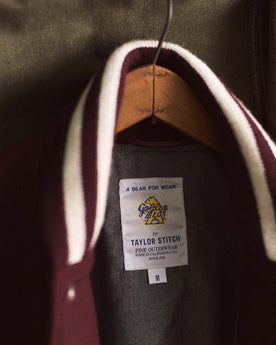 material shot of the tag on The Golden Bear Snap Bomber in Port Wool, Outerwear by Taylor Stitch