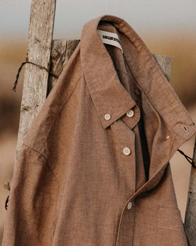 The Jack in Faded Brick Chambray hanging on a fence, Wovens by Taylor Stitch