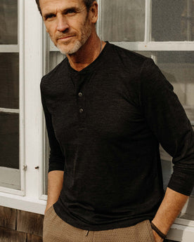 fit model posing in The Merino Henley in Heather Black, Knits by Taylor Stitch