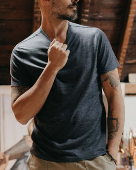 fit model adjusting the collar on The Merino Tee in Heather Navy, Knits by Taylor Stitch