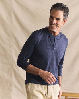 fit model posing in The Merino Henley in Heather Navy, Knits by Taylor Stitch