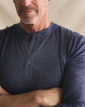 fit model with his arms crossed wearing The Merino Henley in Heather Navy, Knits by Taylor Stitch
