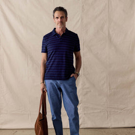fit model posing with his hand in his pocket wearing The Organic Cotton Polo in Washed Indigo Stripe