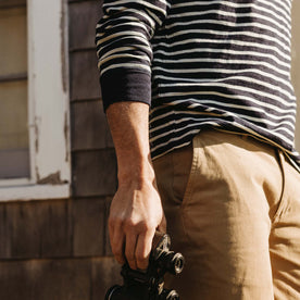 fit model showing off cuffs on The Organic Cotton Henley in Rinsed Indigo Stripe