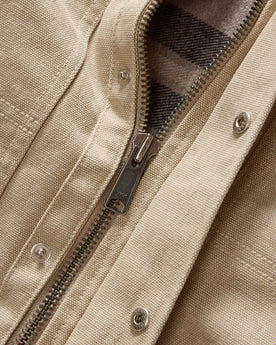 material shot of the YKK zipper on The Workhorse Utility Jacket in Light Khaki Chipped Canvas, Outerwear by Taylor Stitch