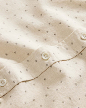 material shot of the natural buttons on The Short Sleeve Jack in Heather Oat Dot, Wovens by Taylor Stitch