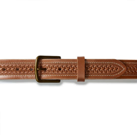 flatlay of the buckle on The Tooled Belt in Saddle Tan