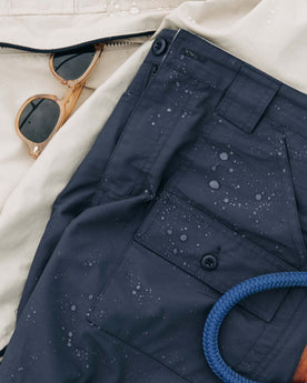 editorial image of The Trail Cargo Short in Faded Navy 60/40 Faille with water drops , Bottoms by Taylor Stitch