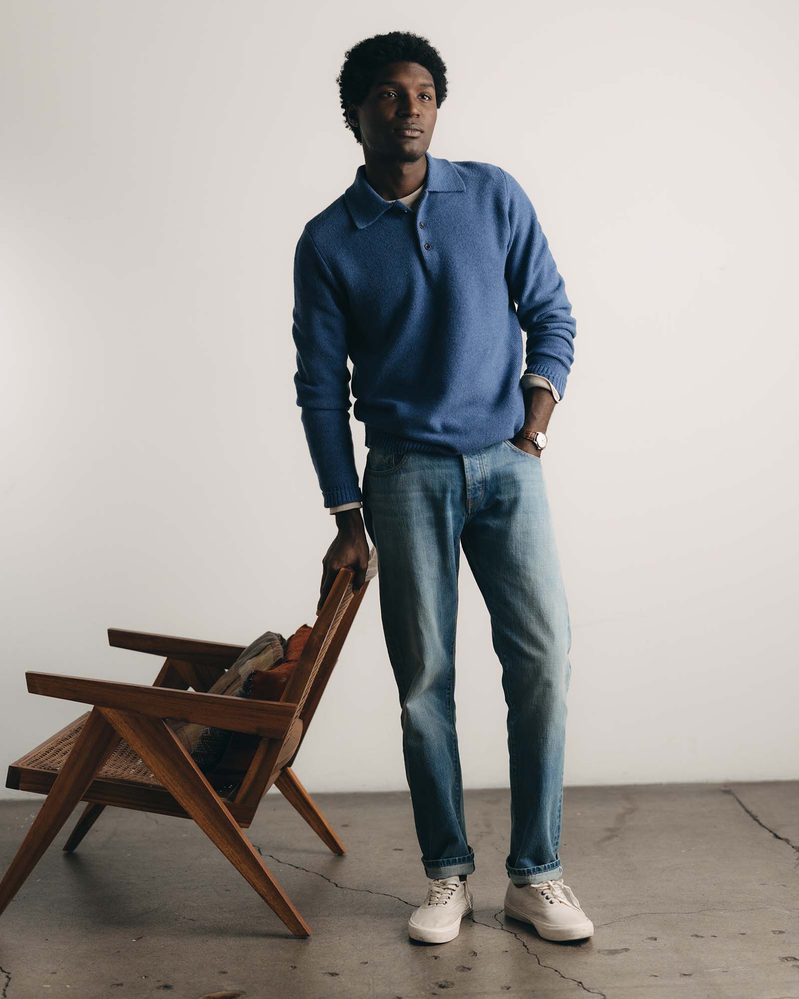 fit model posing in The Newton Sweater Polo in Heather Clear Blue, Knits by Taylor Stitch